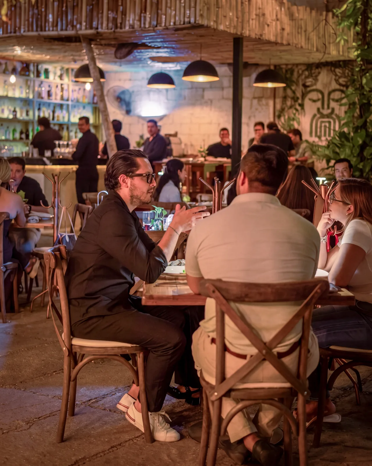 Dinner on Mar Di Vino's terrace with the lit bar and the meander mural in the background